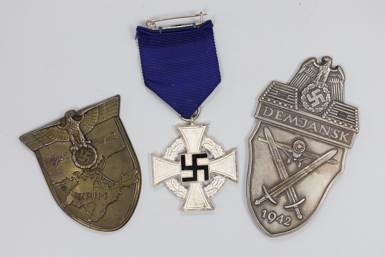 German Third Reich Demanjsk and Luftwaffe Krim badges and a 25 year's faithful service medal